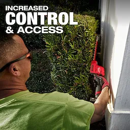 A person in a green shirt uses an M12 FUEL™ 8" Hedge Trimmer to trim a bush near a wall. The text "INCREASED CONTROL & ACCESS" is displayed at the top left.