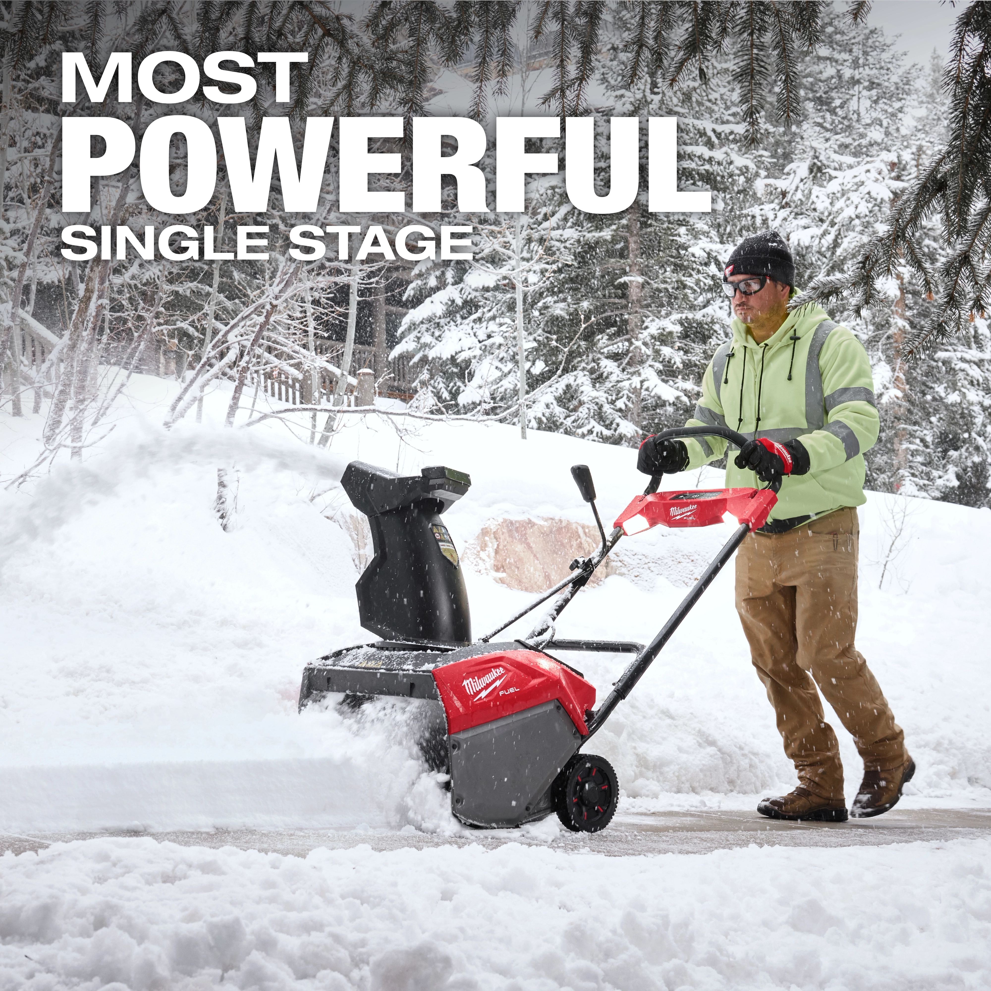 A person uses the M18 FUEL™ 21" Auger Propelled Dual Battery Single Stage Snow Blower to clear snow from a walkway. The image highlights the power of the snow blower in a snowy outdoor setting, with a prominent "MOST POWERFUL SINGLE STAGE" text written above.