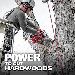 A person uses an M18 FUEL™ 12" Top Handle Chainsaw to cut a large tree branch. The text "POWER TO CUT HARDWOODS" is displayed at the bottom of the image.