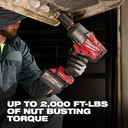 Worker using M18 FUEL 3/4" High Torque Impact Wrench w/ ONE-KEY Kit under a metal structure.
