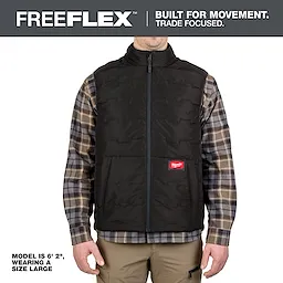 FreeFlex™ Lightweight Insulated Vest Black shown on a model wearing a size large. The vest features a front zipper, Milwaukee logo, and is worn over a plaid shirt with beige pants. The product emphasizes mobility and durability for tradespeople.