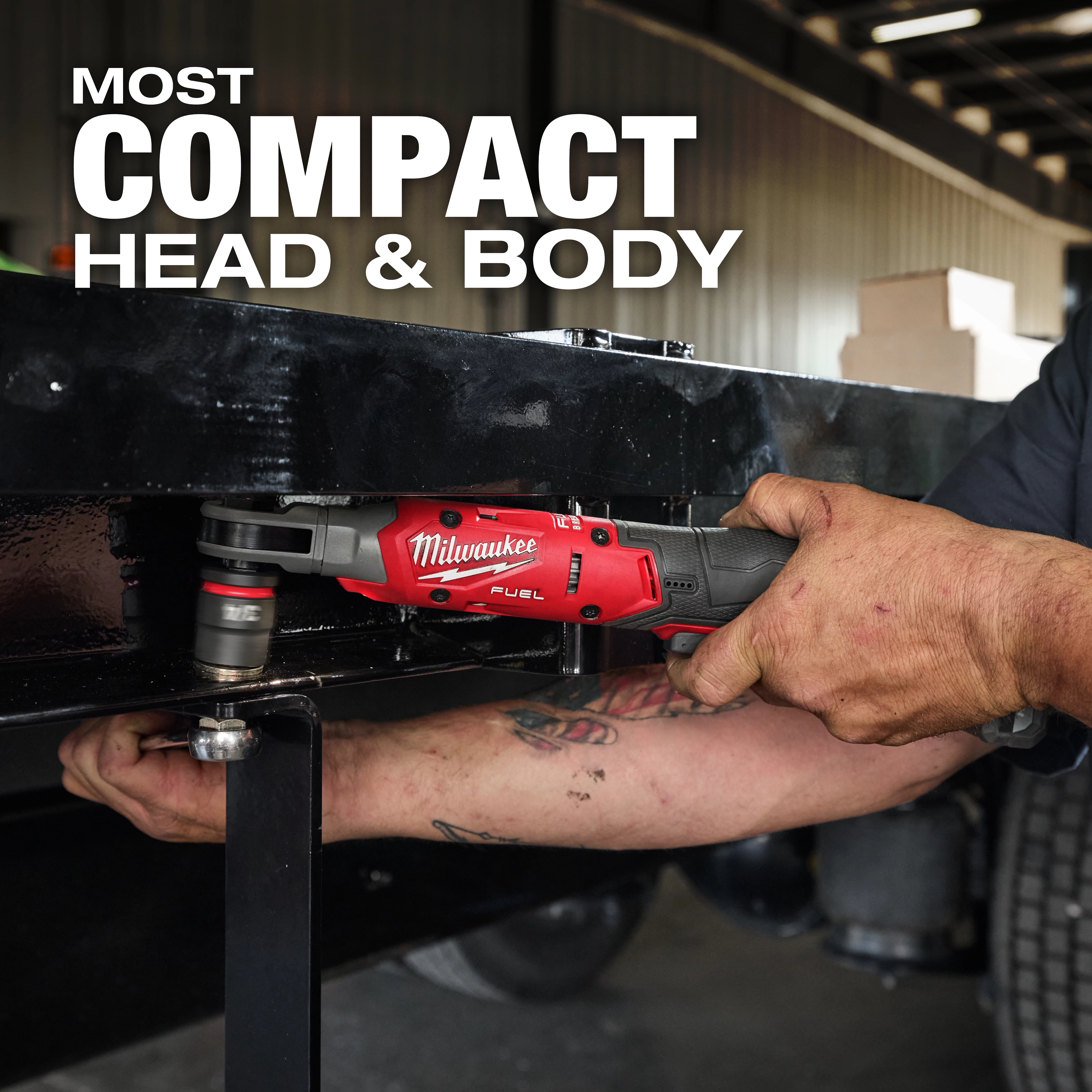 A person operates the M12 FUEL™ 1/2" Ratchet on a black metal frame in an industrial setting. The text "MOST COMPACT HEAD & BODY" is displayed above the tool.