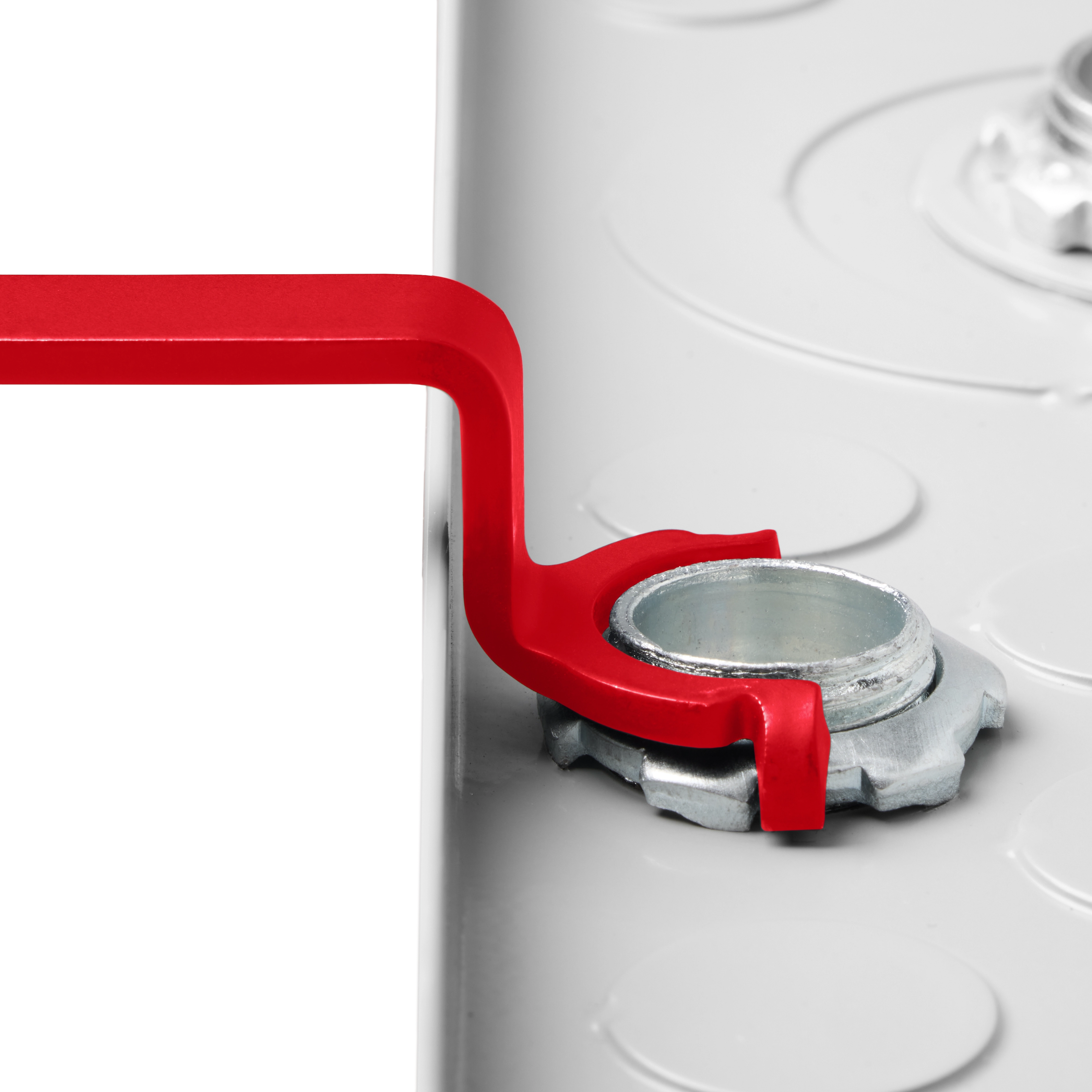 A red wrench from the 3 PC Locknut Wrench Set is being used to tighten a silver locknut on a white surface.