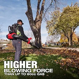 A person uses the M18 FUEL™ Dual Battery Backpack Blower to clear leaves in a residential yard. The text on the image reads: "HIGHER BLOWING FORCE THAN UP TO 60cc GAS." Trees and houses are visible in the background.