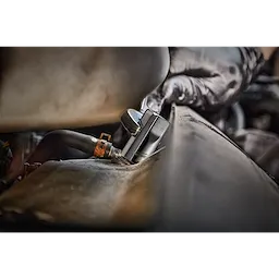 A person wearing black gloves uses a tool to work on a car engine. The tool is part of a 12pc 1/4”, 3/8”, & 1/2” Drive External Torx Socket Set.