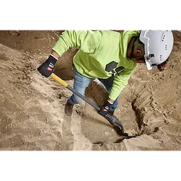 Worker digging in dirt with a shovel wearing Cut Level 1 Nitrile Dipped Gloves w/ WEAR-DEFENSE Protection.