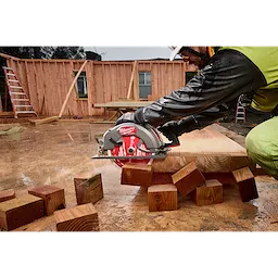 Worker using a circular saw with the 10-1/4” 28T Thick Kerf Framing Circular Saw Blade on a wet construction site.