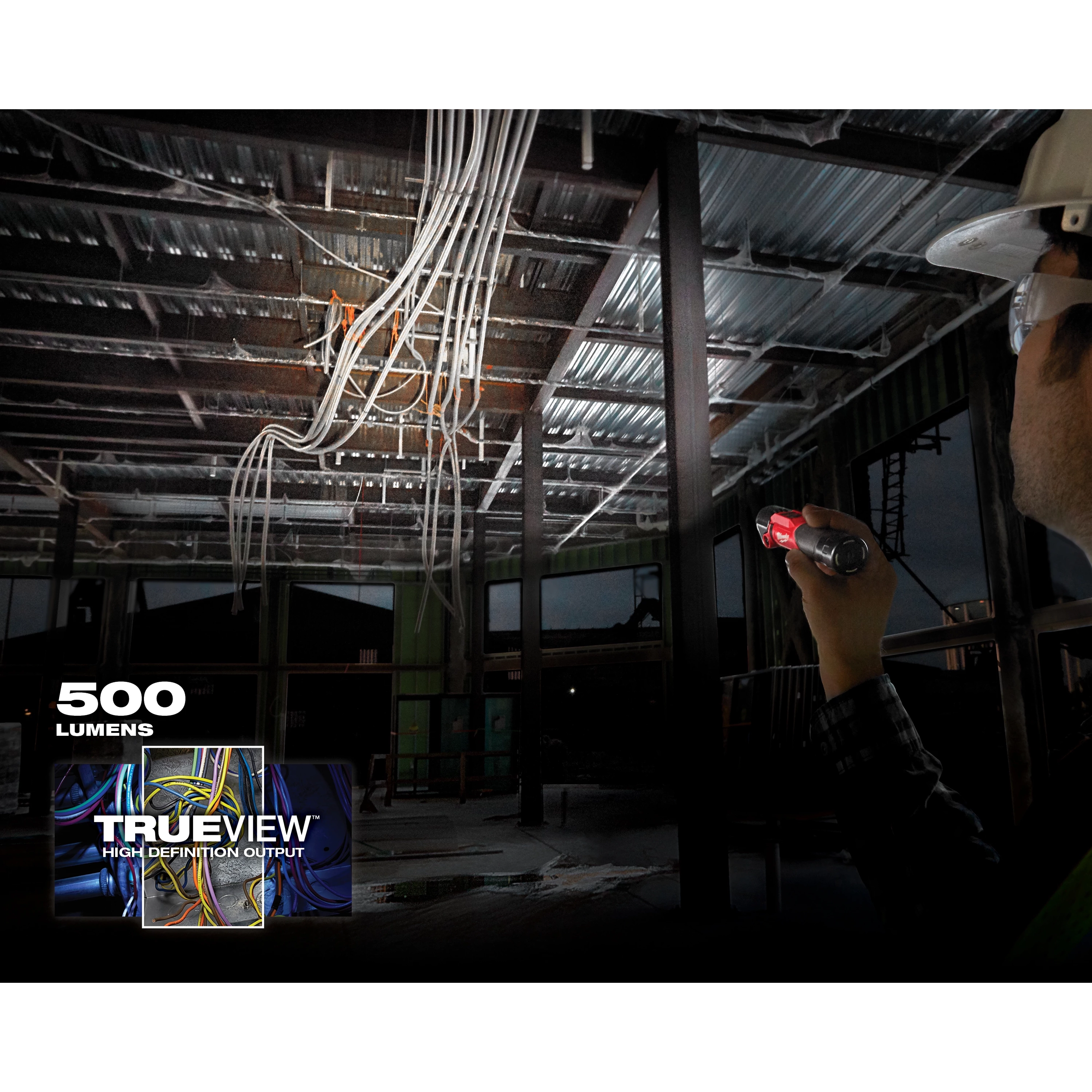 Person shines a REDLITHIUM USB Pivoting Flashlight in a construction area with hanging wires. Text reads "500 lumens" and "Trueview."
