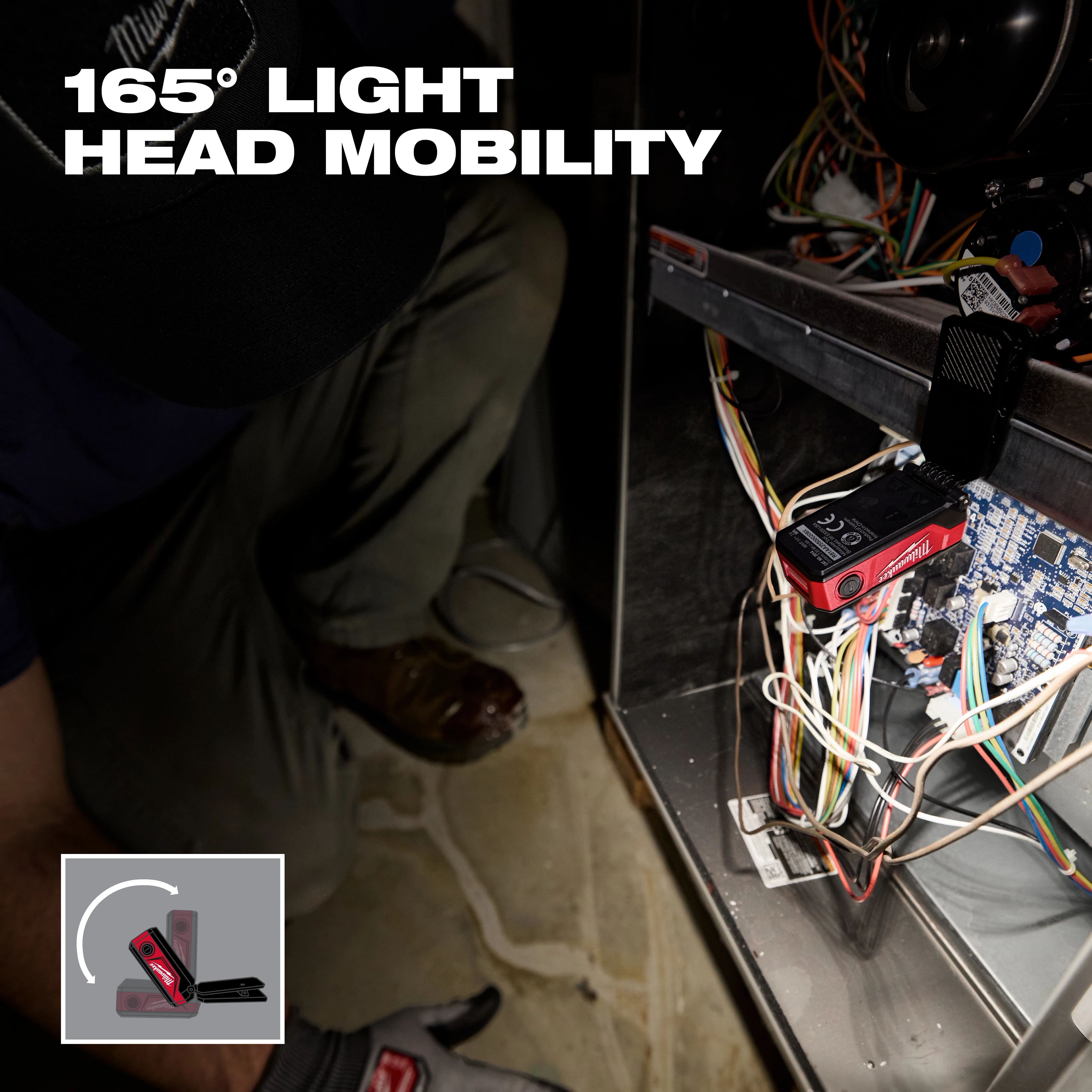 Milwaukee pivoting light illuminates wiring inside an open electrical panel.