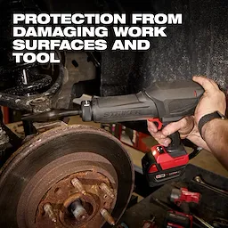 Hand holding an M18 FUEL STRIKER Hammer Chisel near a vehicle brake assembly in a workshop.