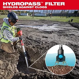 A worker uses an M18™ Brushless Stick Transfer Pump to remove water from a muddy construction site. The top of the image displays text: "HYDROPASS™ FILTER SHIELDS AGAINST CLOGS." An inset shows a close-up of the filter preventing debris from clogging the pump.