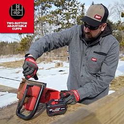 Person using a chainsaw outdoors while wearing a GRIDIRON Flannel Shirt and work gloves.