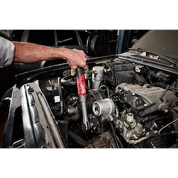 M12 FUEL 1/2" Extended Reach Ratchet being used on an engine component under an open car hood.