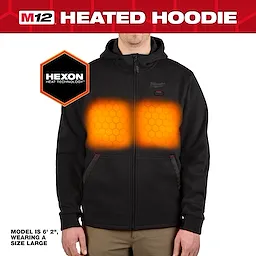 The M12™ Heated Hoodie is a black, zip-up sweatshirt featuring heating zones on the chest. The model is 6'2" and wears a size large. Hexon Heat Technology provides warmth, highlighted with orange hexagon patterns in the heating areas. Name brand logo is visible on the upper left side.