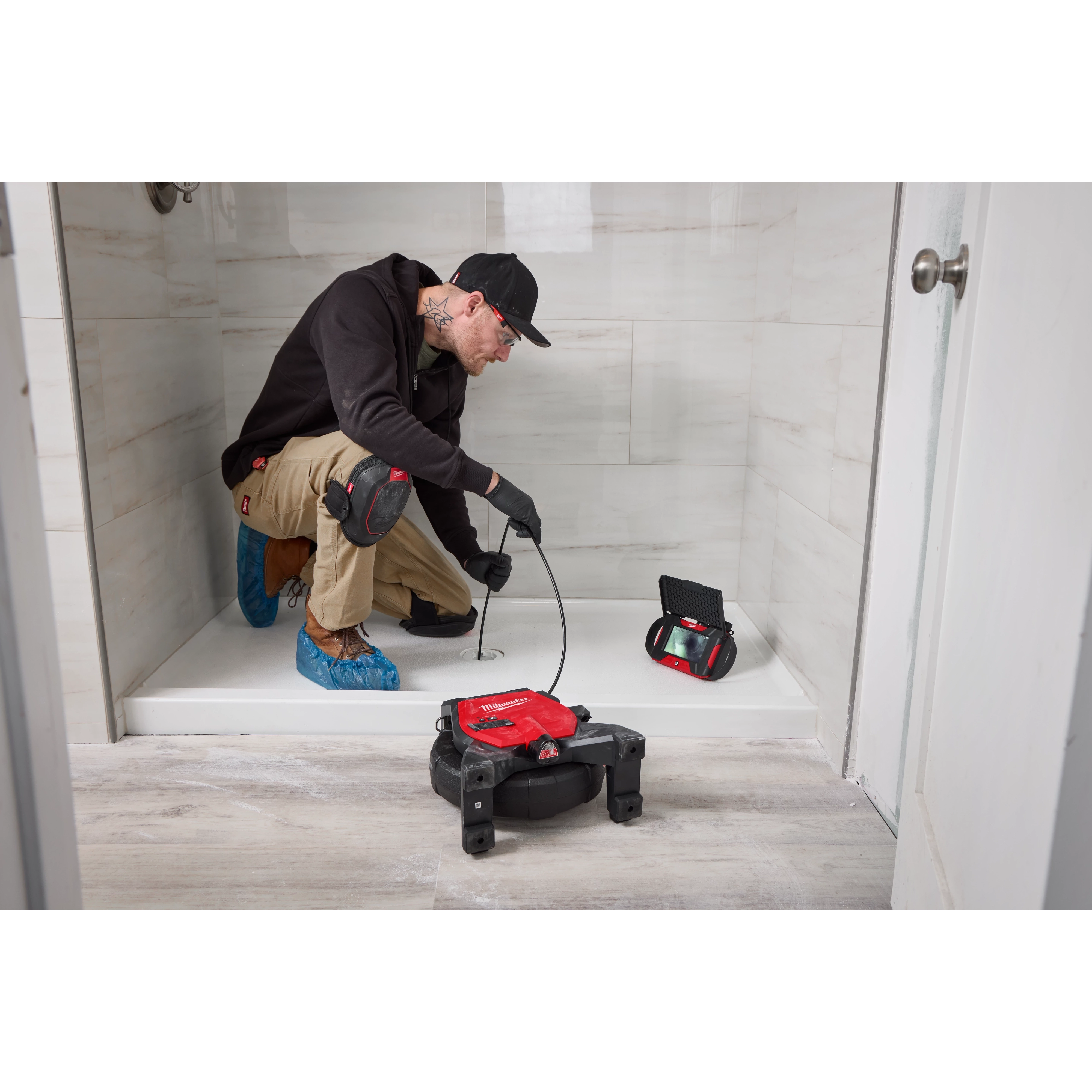 Image of the Milwaukee M12™ 65’ Ultra Flex Compact Inspection Camera Kit being used by a worker on a jobsite