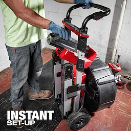 Person operating the MX FUEL Sewer Drum Machine with "INSTANT SET-UP" text overlay. The machine is equipped with large wheels and a handle.