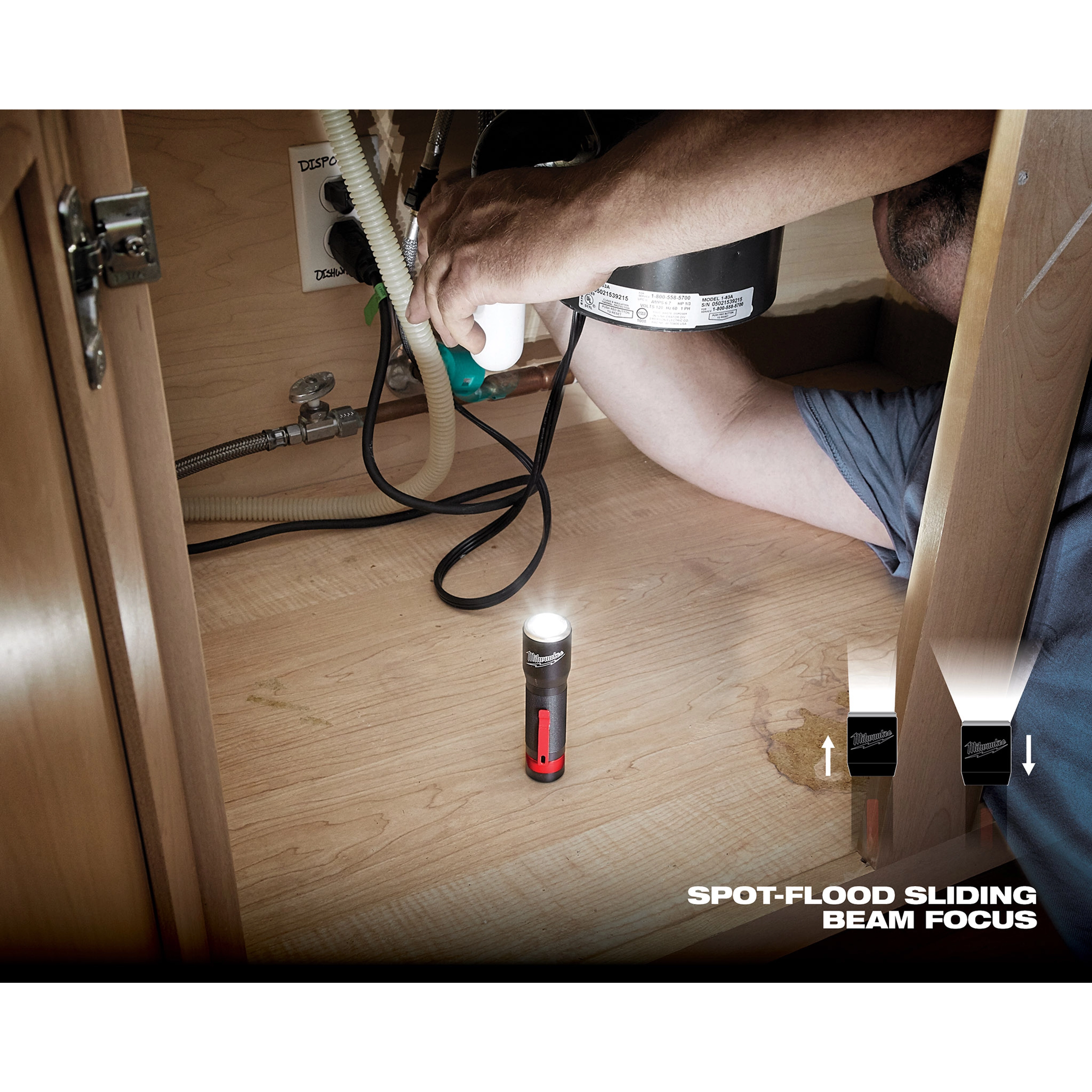 Person using the App Shot with overlay flashlight under a kitchen sink for plumbing work, with a beam focus feature illustrated.