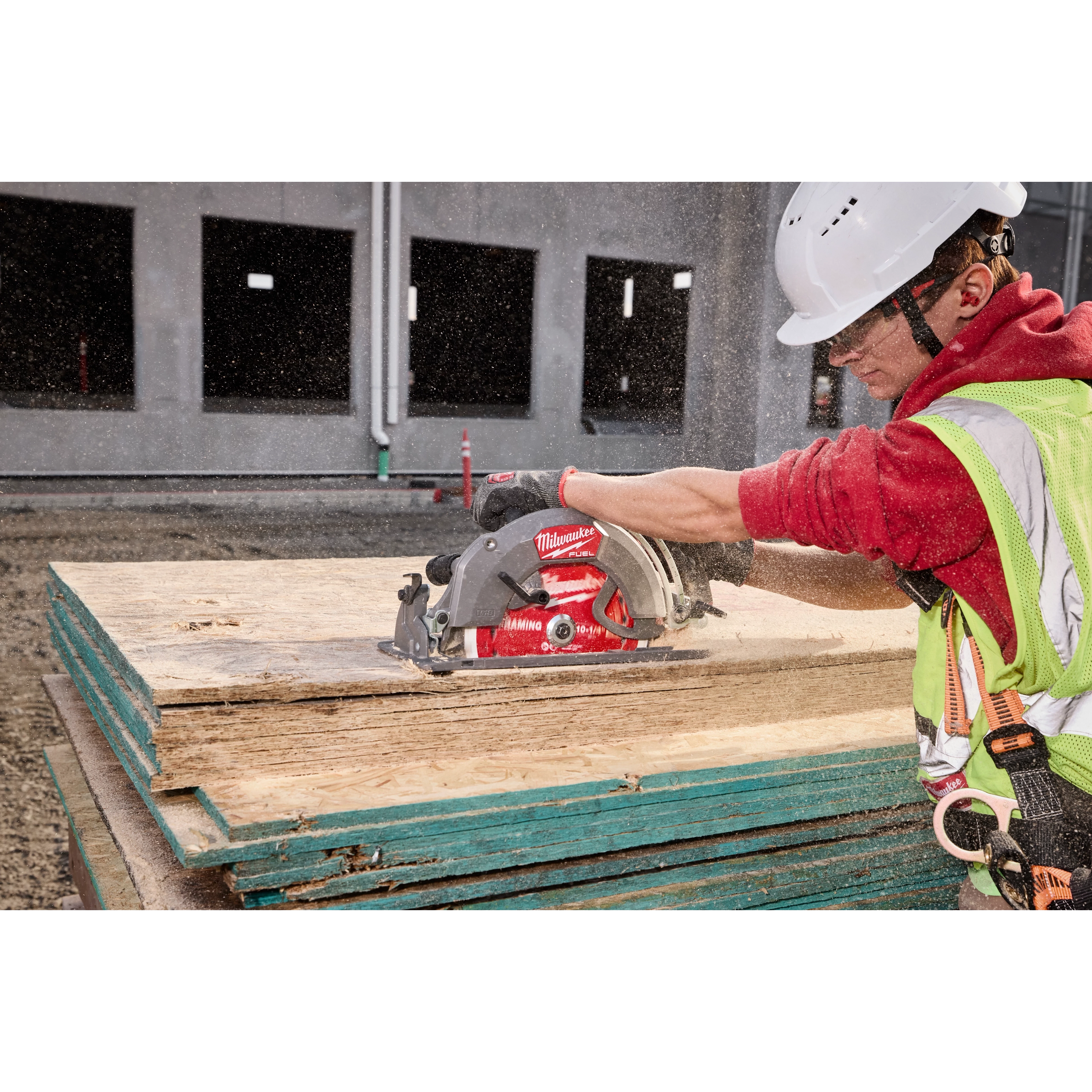 Worker cutting plywood using a circular saw with a 10-1/4” 28T Thick Kerf Framing Circular Saw Blade on a construction site.