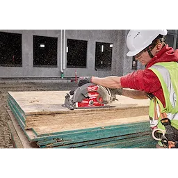 Worker cutting plywood using a circular saw with a 10-1/4” 28T Thick Kerf Framing Circular Saw Blade on a construction site.