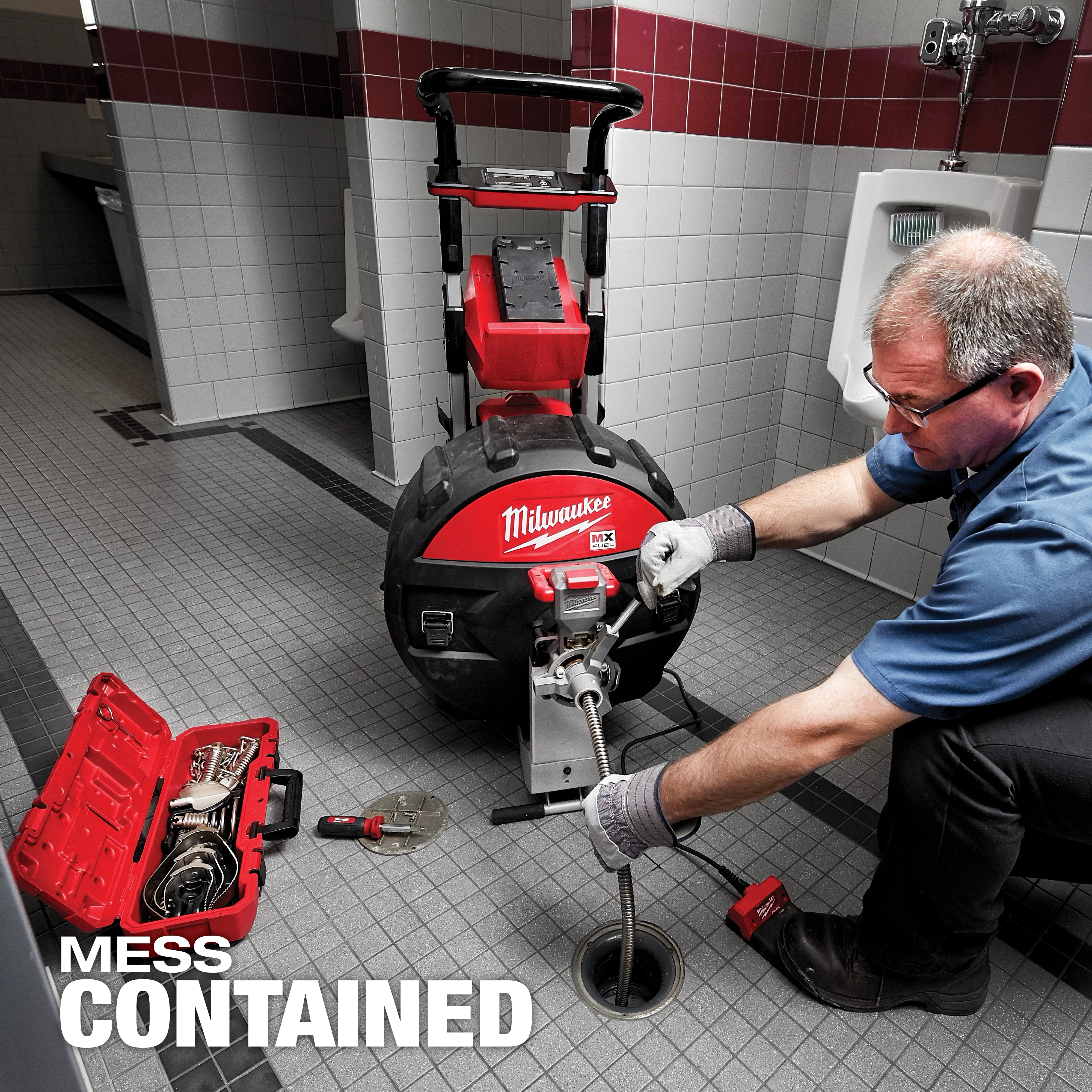MX FUEL Sewer Drum Machine in use at a tiled floor maintenance site with a toolbox and various tools nearby. Text reads "MESS CONTAINED."