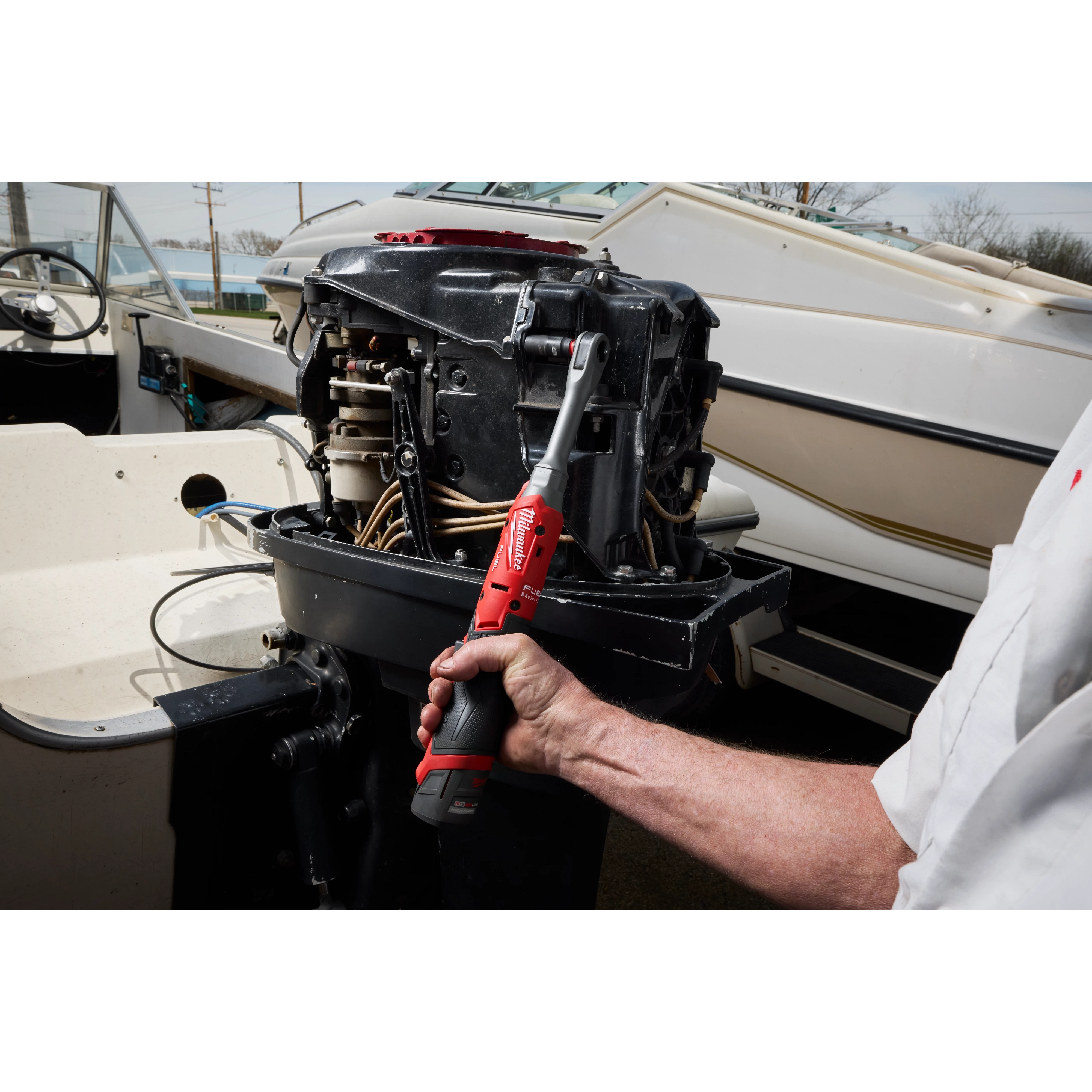 M12 FUEL 1/2" Extended Reach Ratchet tightening a fastener on an exposed boat engine.