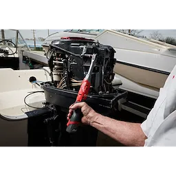 M12 FUEL 1/2" Extended Reach Ratchet tightening a fastener on an exposed boat engine.