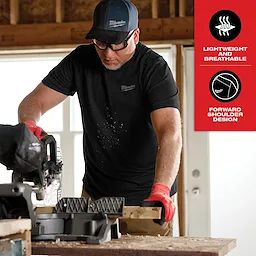 Hybrid Work Tee - Short Sleeve Feature Shot. A person is using a power saw while wearing a black short-sleeve tee, featuring lightweight and breathable fabric with forward shoulder design.