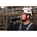 Image of a worker drinking from a Milwaukee PACKOUT Insulated Bottle with Chug Lid in black