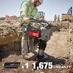 A construction worker operates an MX FUEL™ 70 kg Rammer in a trench at a job site. Various workers and construction equipment are visible in the background. In the foreground, text shows a battery and the figures " x1" and "1,675 LINEAR FT."