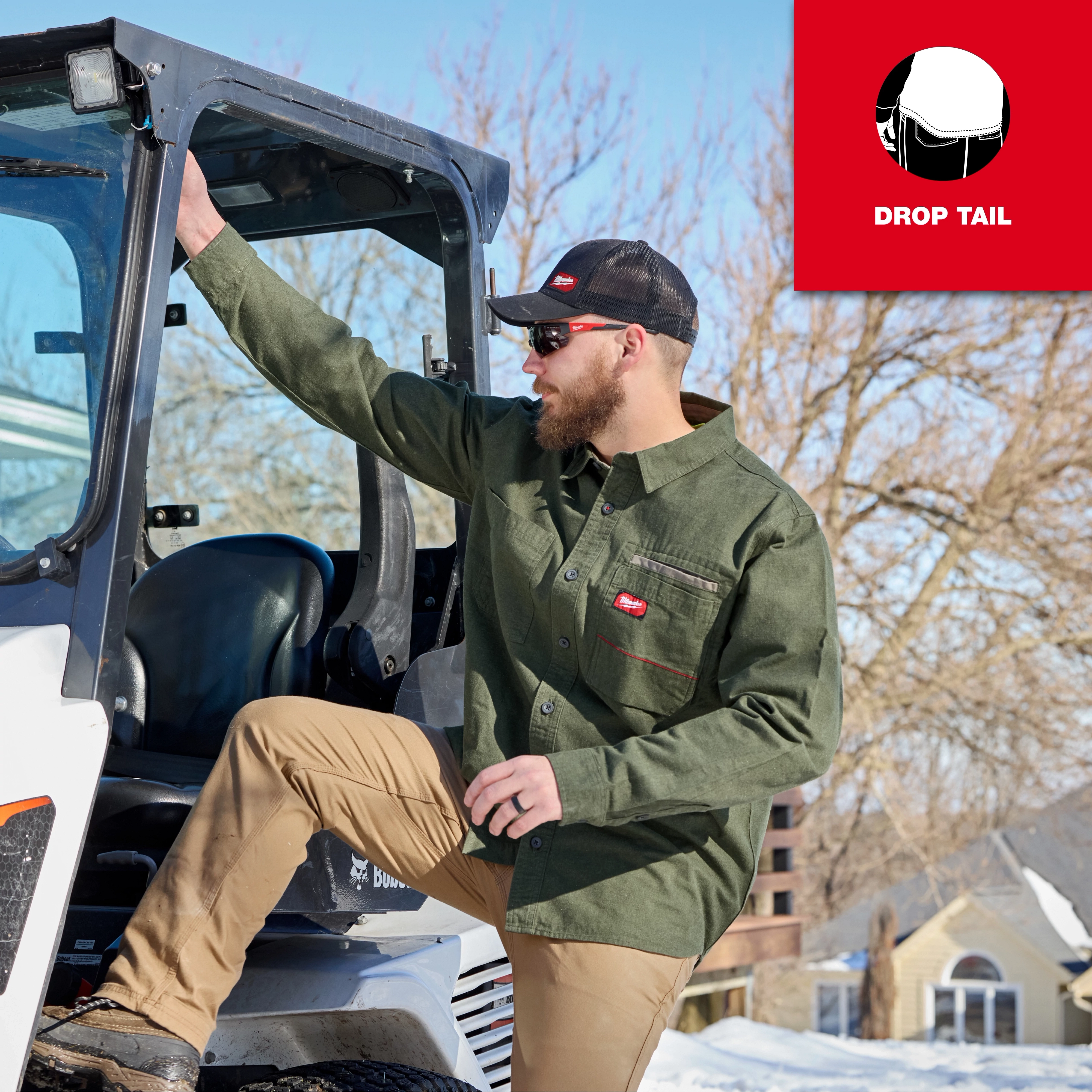 Person wearing a GRIDIRON Flannel Shirt stepping into a work vehicle in a snowy outdoor setting.