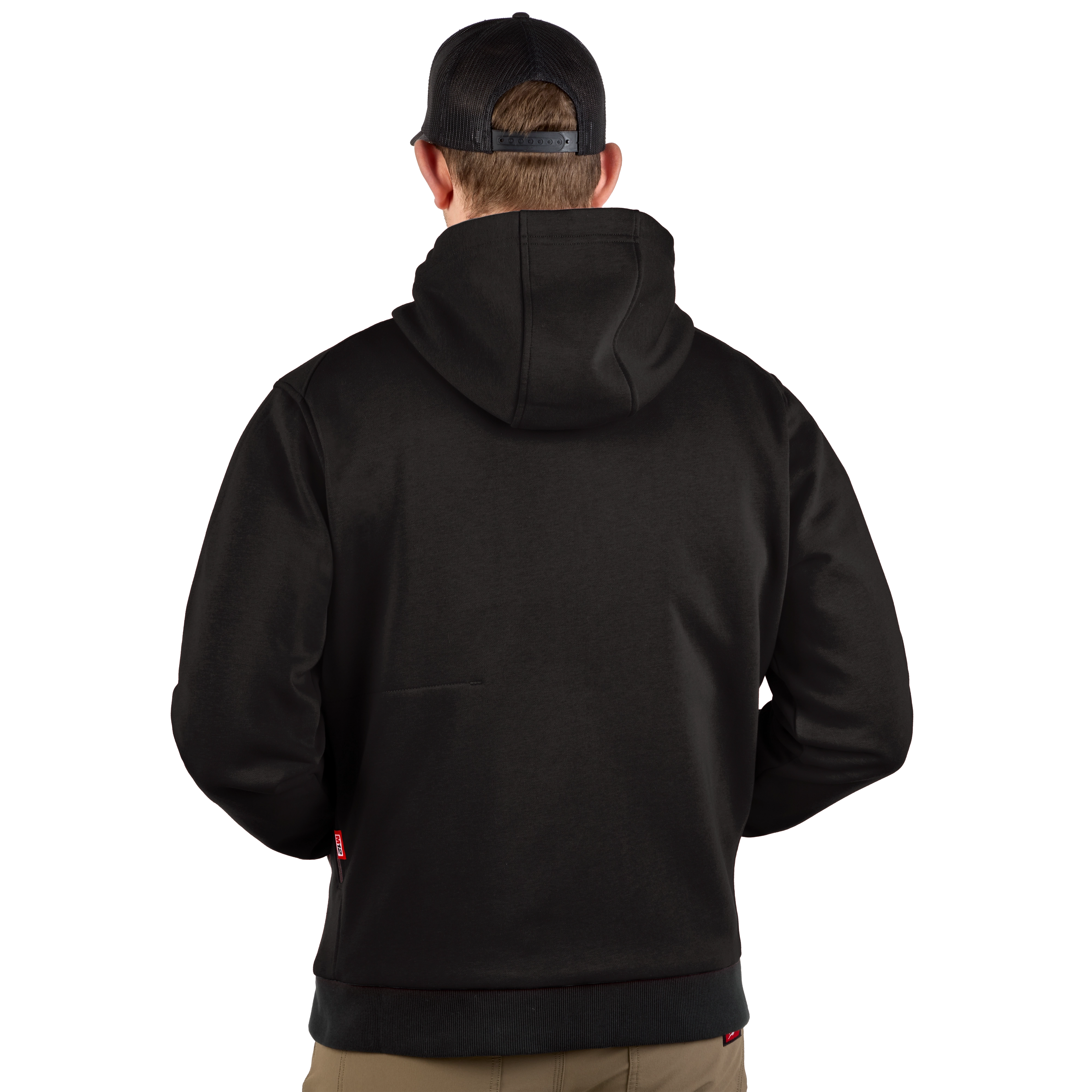 A person wearing the black M12™ Heated Hoodie is shown from the back. The hoodie features a hood and is paired with a black cap and brown trousers.