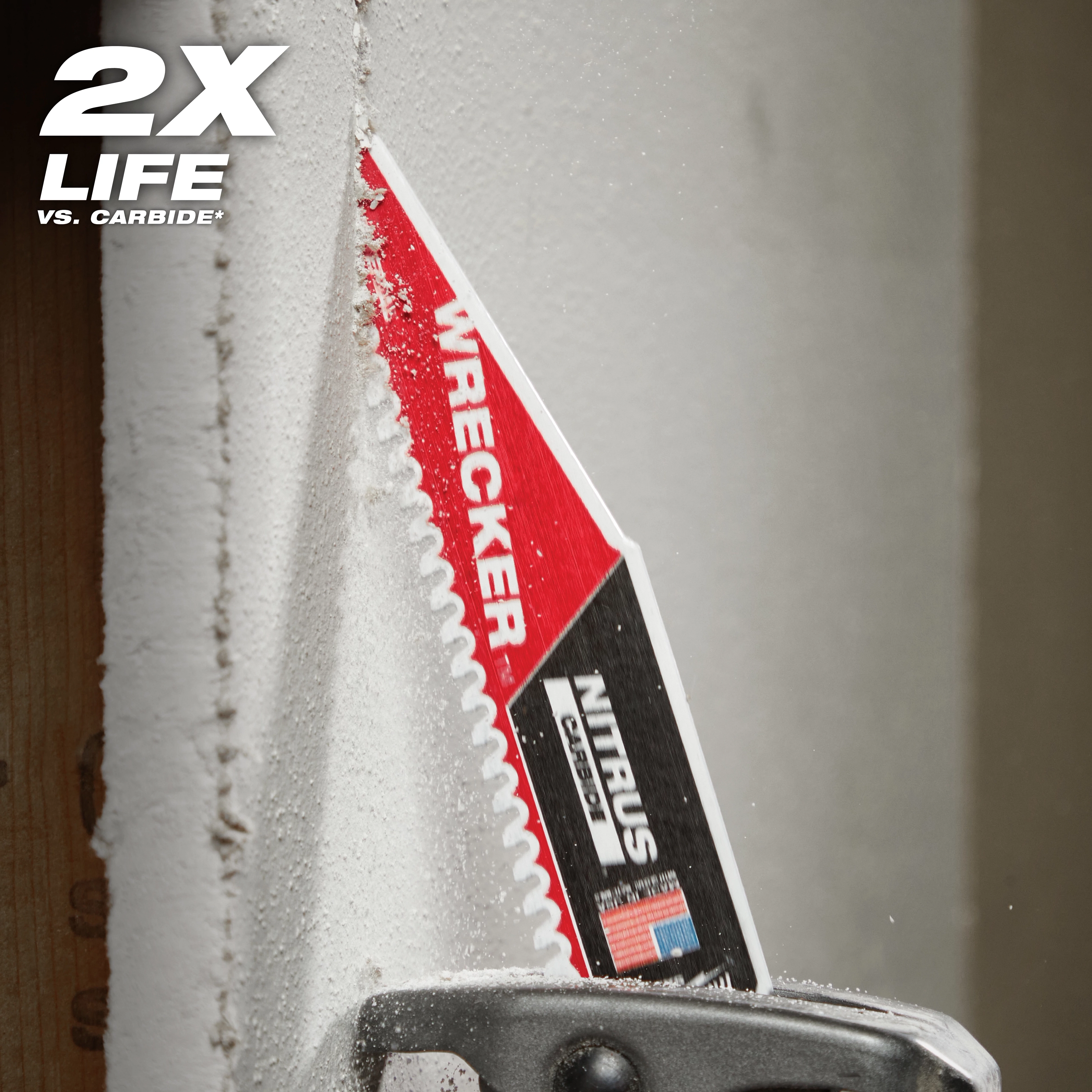 The Milwaukee Wrecker Nitrus Carbide Saw Blade is cutting through dense material. The blade is close to a wooden beam, producing fine dust particles. The text "2X LIFE" is prominently displayed in the top left corner.