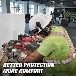 Worker wearing a BOLT 4PT Front Brim Vented Safety Helmet - Type 2, Class C operates a saw on a construction site. Text reads, "Better Protection More Comfort."