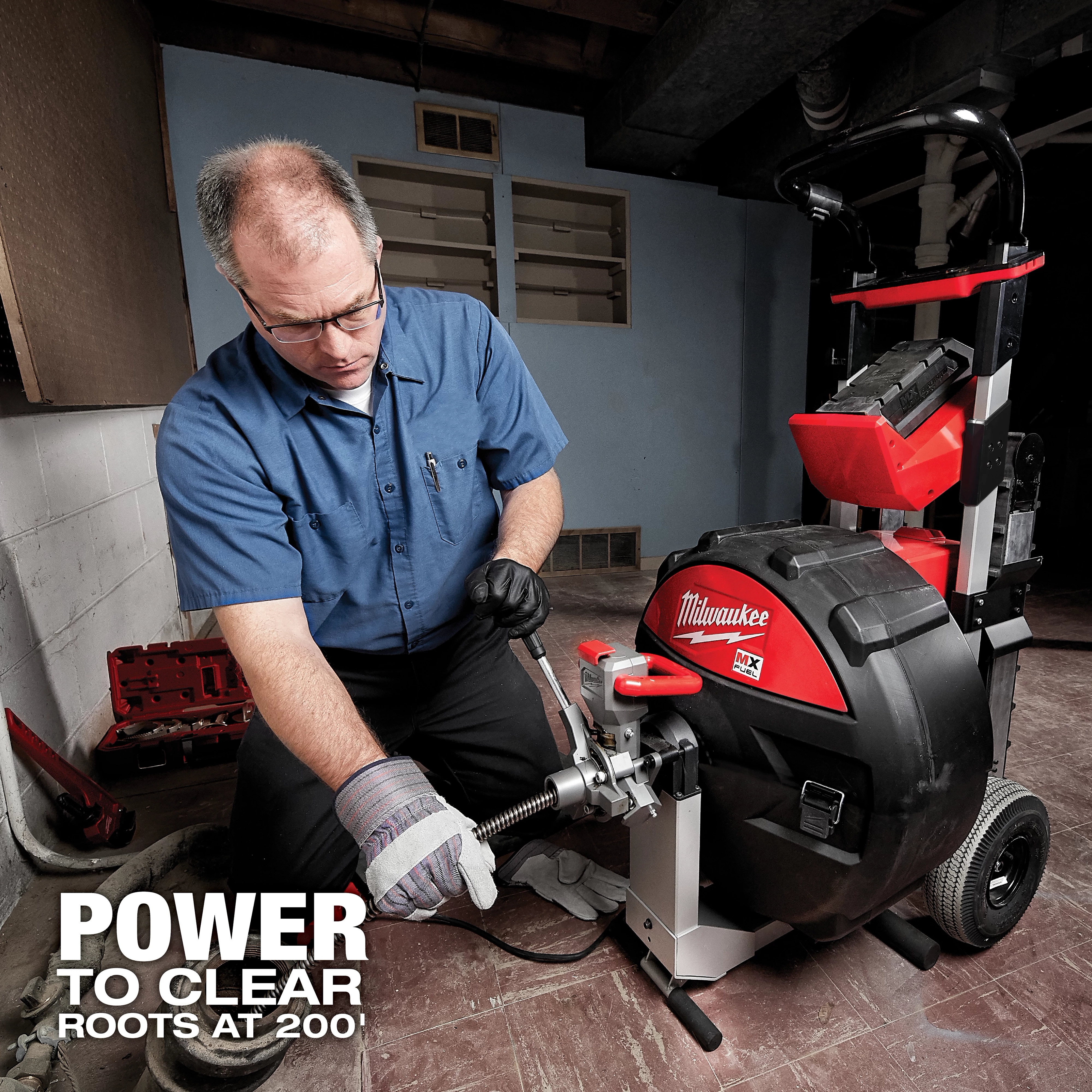 A person operates the MX Fuel Sewer Drum Machine, a powerful plumbing tool, in a basement setting. Text reads "Power to Clear Roots at 200'."