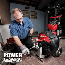 A person operates the MX Fuel Sewer Drum Machine, a powerful plumbing tool, in a basement setting. Text reads "Power to Clear Roots at 200'."