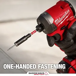 A close-up of a gloved hand using a Milwaukee Fuel impact driver with a Shockwave Impact Duty bit to fasten a screw. The text at the bottom reads “ONE-HANDED FASTENING.” The advertisement highlights the product's ease of use with one hand.