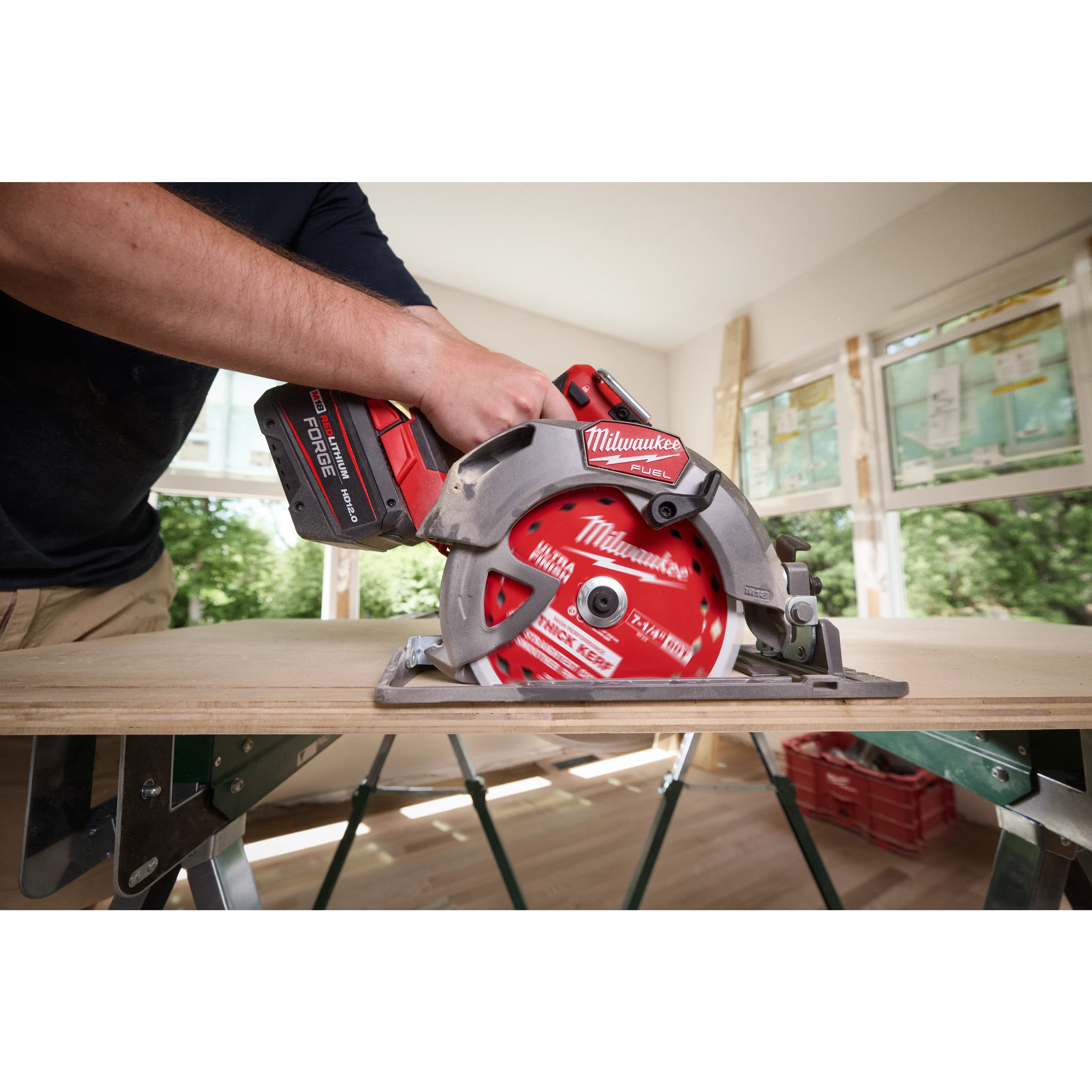 7-1/4" 60T Thick Kerf Ultra Finish Circular Saw Blade mounted on a cordless saw cutting a board indoors.
