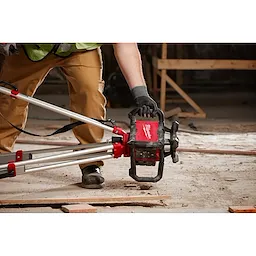 Image of the Milwaukee M18 Green Interior Rotary Laser Level Kit w/ Remote/Receiver & Wall Mount Bracket being put on a stand by a worker on a jobsite