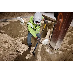Worker digging in a trench wearing Cut Level 5 High Dexterity Nitrile Dipped Gloves with WEAR-DEFENSE Protection.