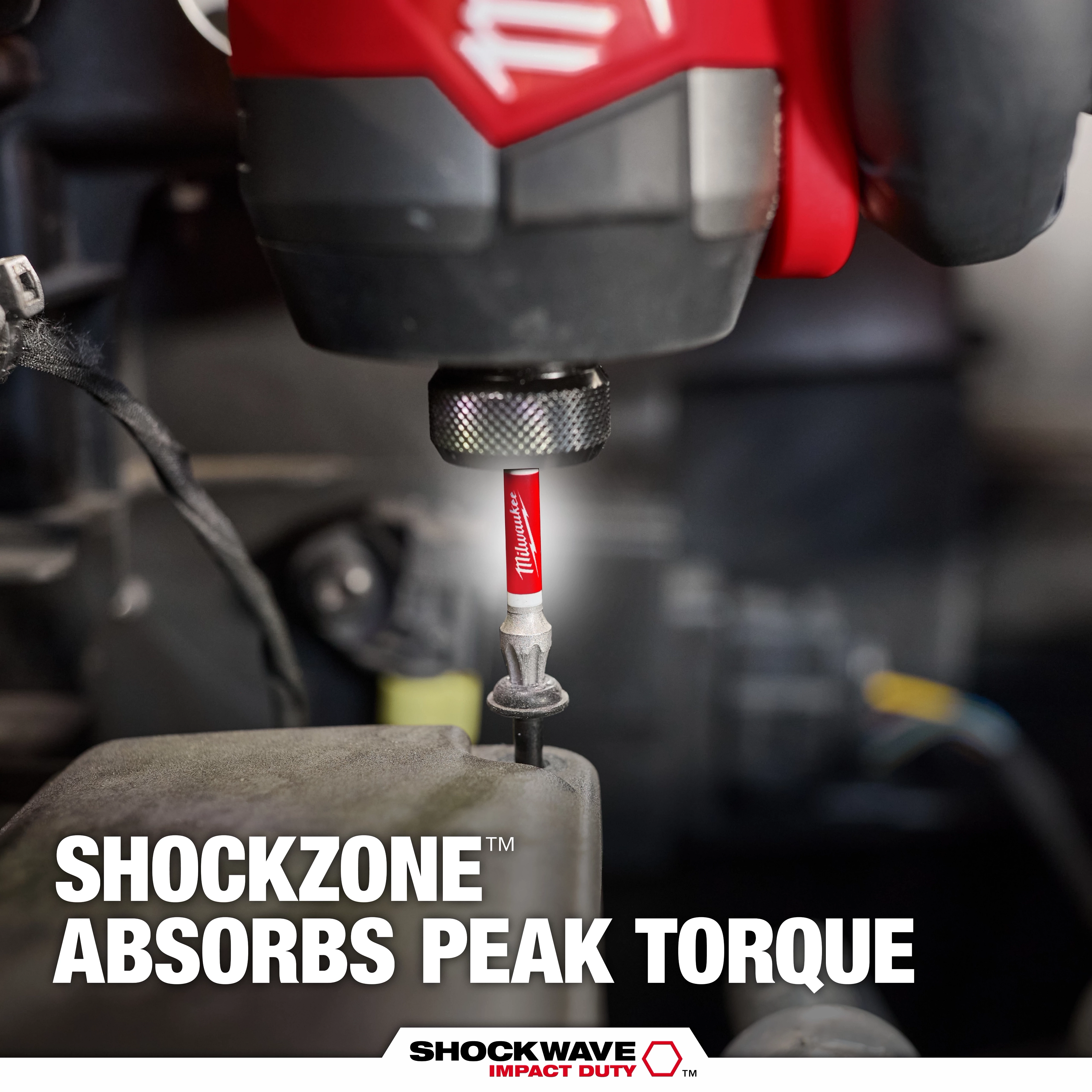 The image shows a close-up of the SHOCKWAVE™ SHOCKZONE™ TORX® Bit being used with a power tool. The bit is red and has "SHOCKWAVE IMPACT DUTY™" written on it. The text claims "SHOCKZONE™ absorbs peak torque" at the bottom of the image.