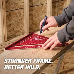 A person marks wood using a red 12" Rafter Square and a pencil. The background shows wooden framing and a partially finished wall. The text "STRONGER FRAME. BETTER HOLD." is displayed in the bottom left corner.