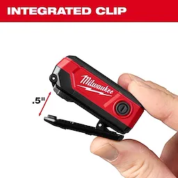 Hand holding a compact red Milwaukee tool with an integrated clip extended to .5 inches.