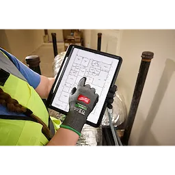 Cut Level 6 High Dexterity Nitrile Dipped Gloves w/ WEAR-DEFENSE Protection tapping a floor plan on a tablet.