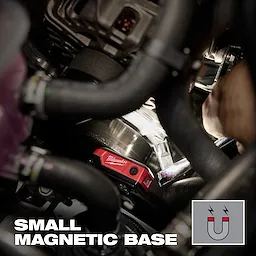 Milwaukee magnetic level with small magnetic base attached inside a crowded engine bay.