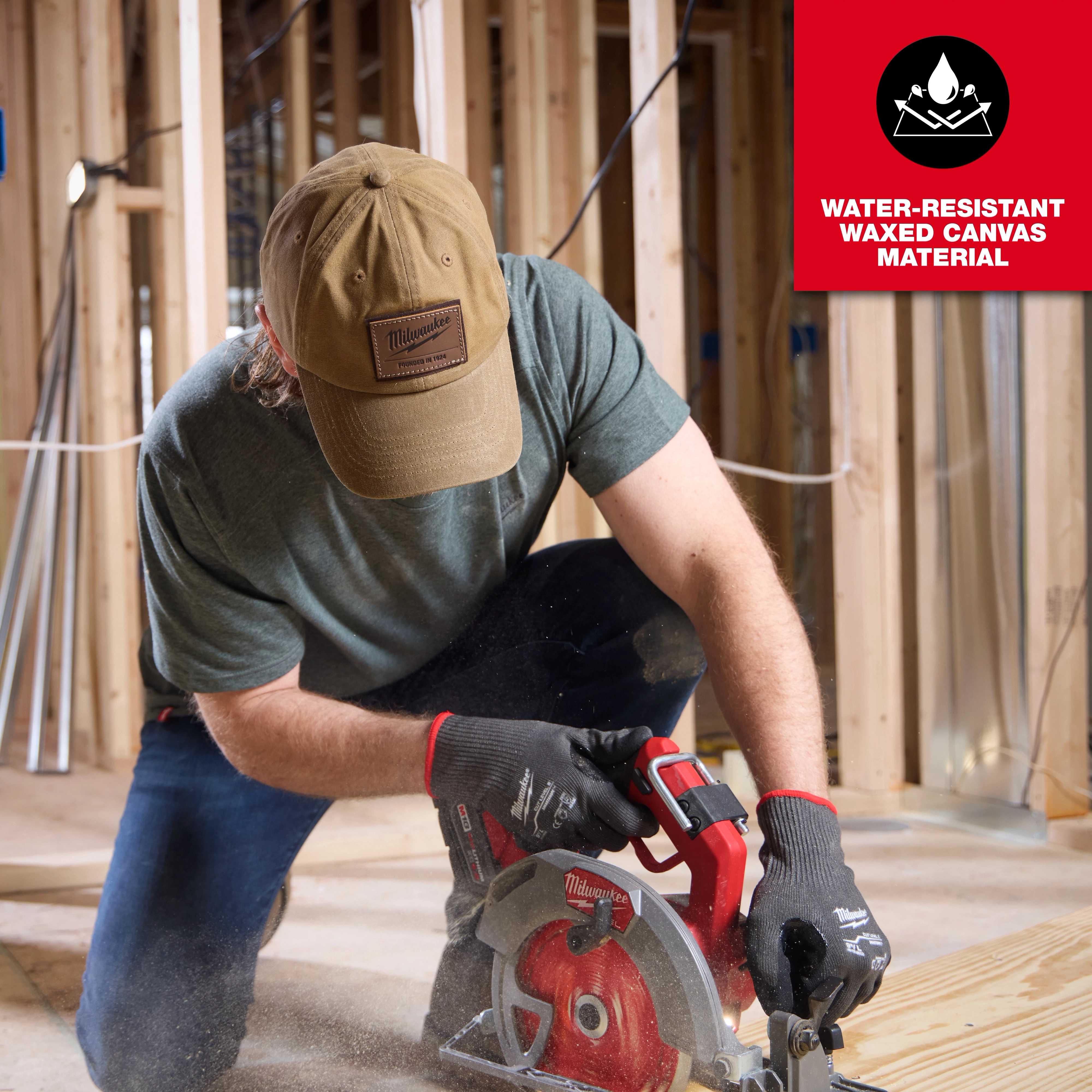 Person in a green shirt wearing a Waxed Canvas Adjustable Hat operates a circular saw. Text reads "Water-Resistant Waxed Canvas Material."