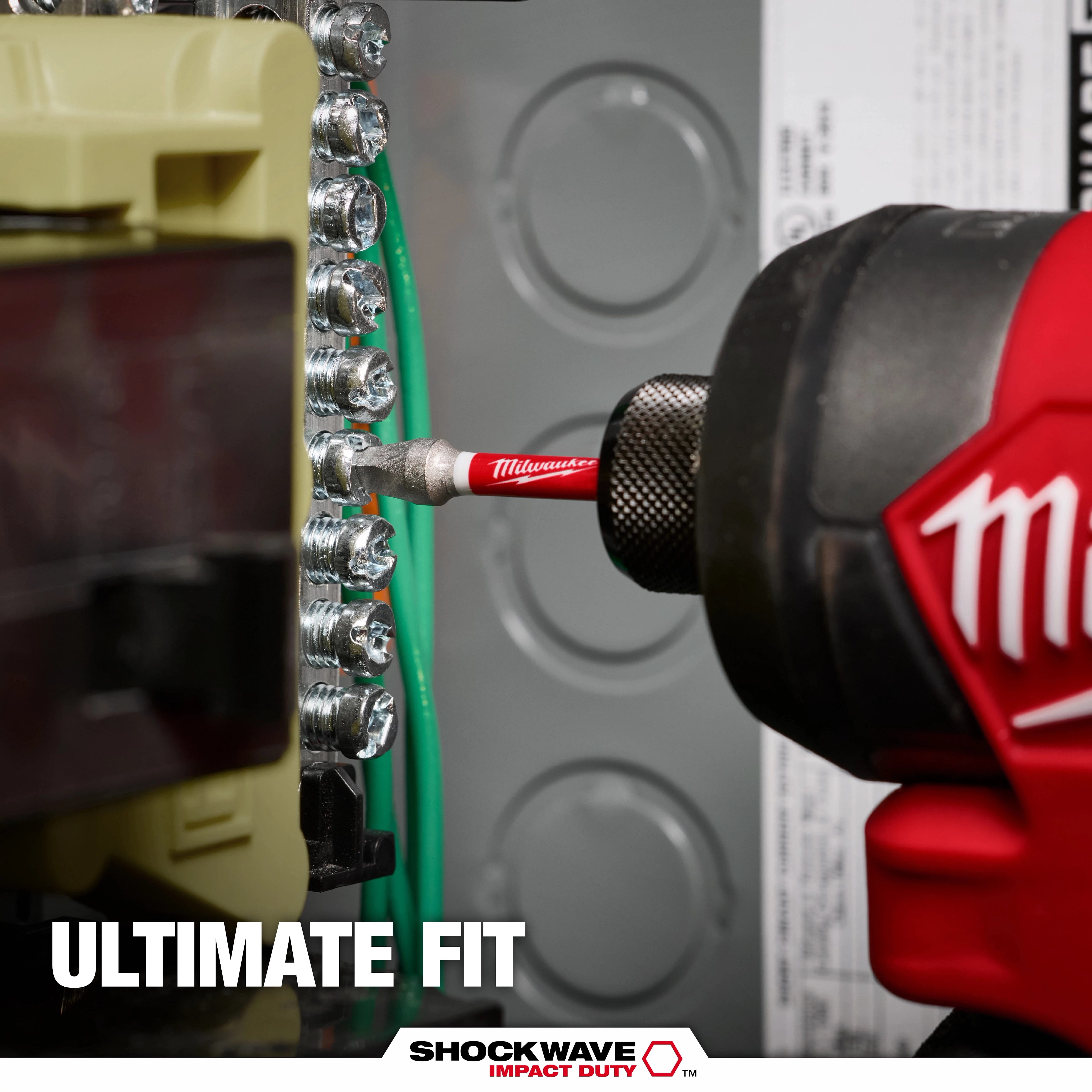 A Milwaukee power tool is shown using a red SHOCKWAVE™ Square Bit to screw into a panel of connectors. Text on the image reads "Ultimate Fit." The SHOCKWAVE Impact Duty logo is displayed at the bottom.