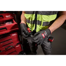 Worker wearing Cut Level 5 High Dexterity Nitrile Dipped Gloves w/ WEAR-DEFENSE Protection using a hand tool.