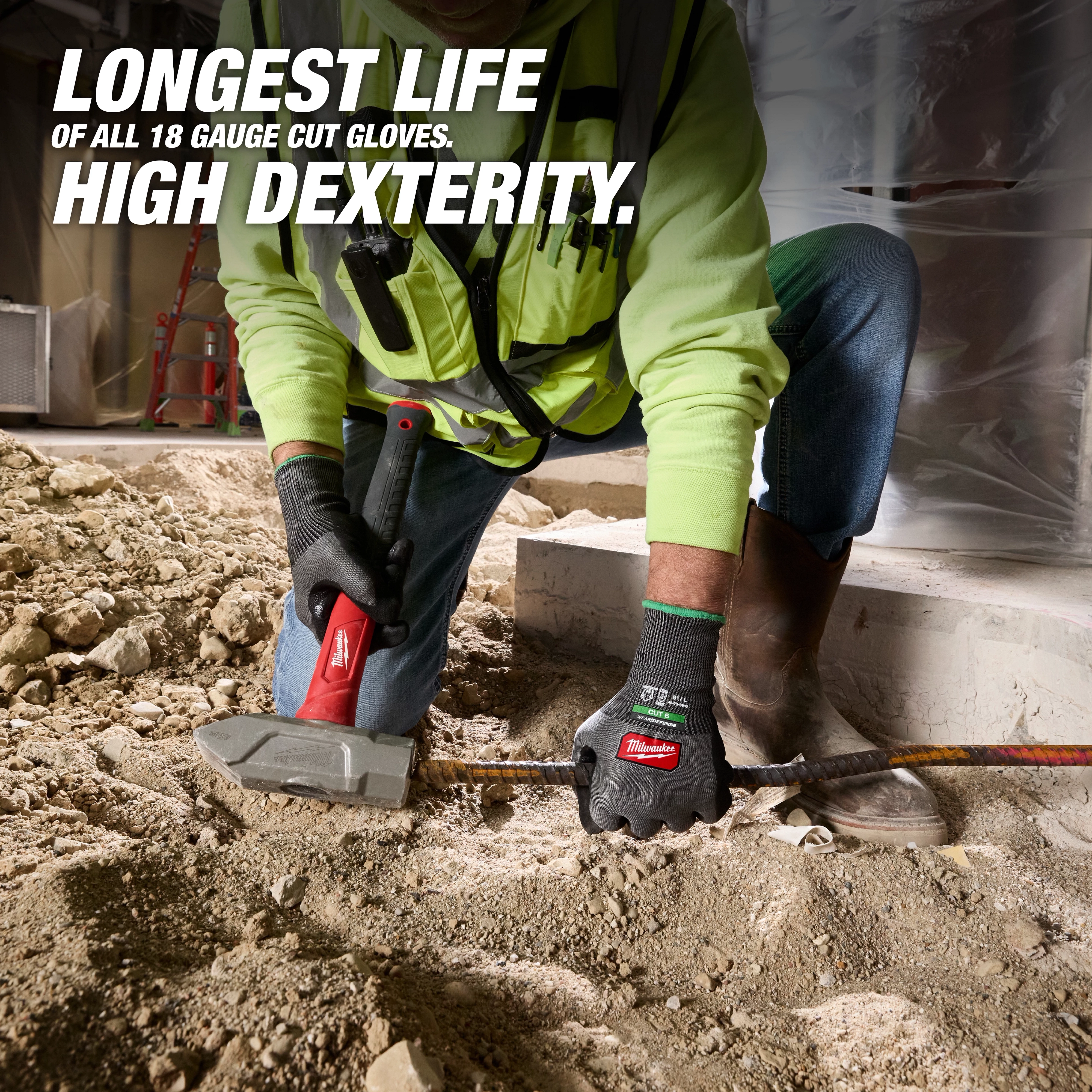 Worker using Cut Level 6 High Dexterity Nitrile Dipped Gloves w/ WEAR-DEFENSE Protection on a dusty construction floor.