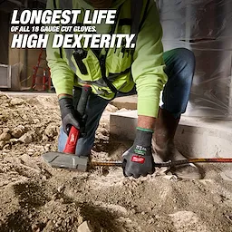 Worker using Cut Level 6 High Dexterity Nitrile Dipped Gloves w/ WEAR-DEFENSE Protection on a dusty construction floor.