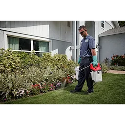 Man using the M12 Handheld Sprayer on bushes